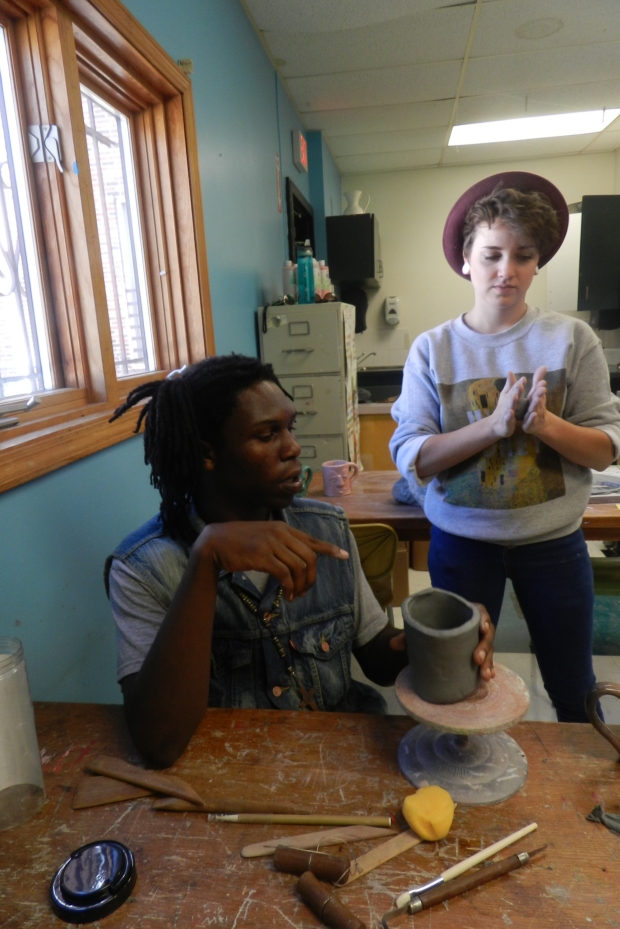 Jenny Greene, junior in sculpture, with a DeLaSalle student